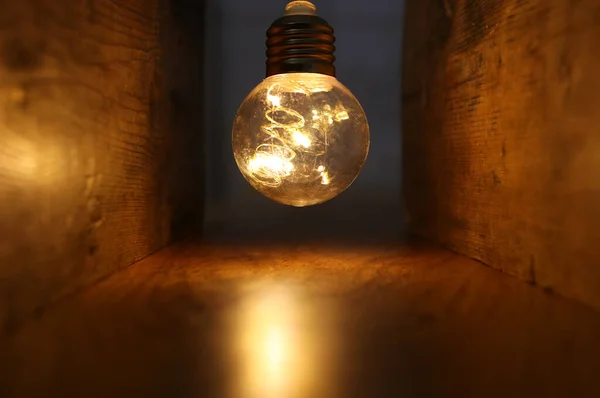 Light bulb lamps with warm light over old wooden background
