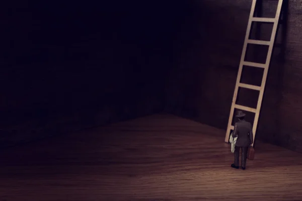 business concept picture of challenge. A man stands infront of a a ladder. Problem solving and decision making.