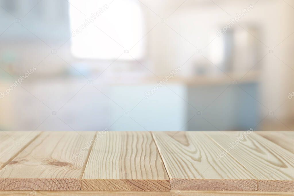 empty table board and defocused modern kitchen background. product display and picnic concept