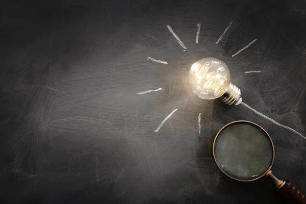 Education and business concept image. Creative idea and innovation. light bulbs as metaphor over blackboard background