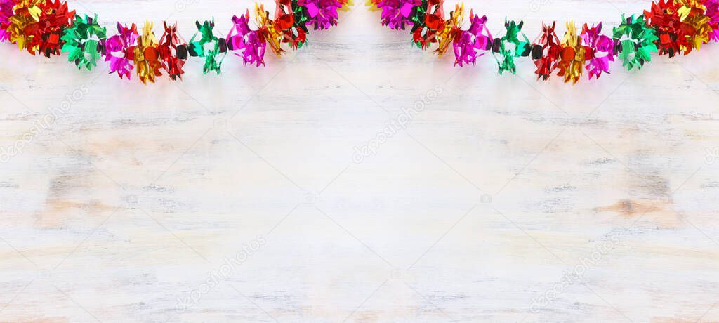 Colorful chain garland over white wooden background. Traditional jewish sukkot holiday decoration