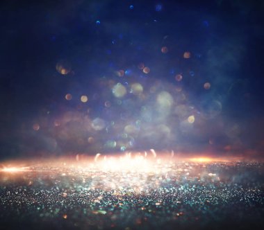 Soyut parıltılı ışıkların arkaplanı. Altın, mavi ve siyah. & Odaklan