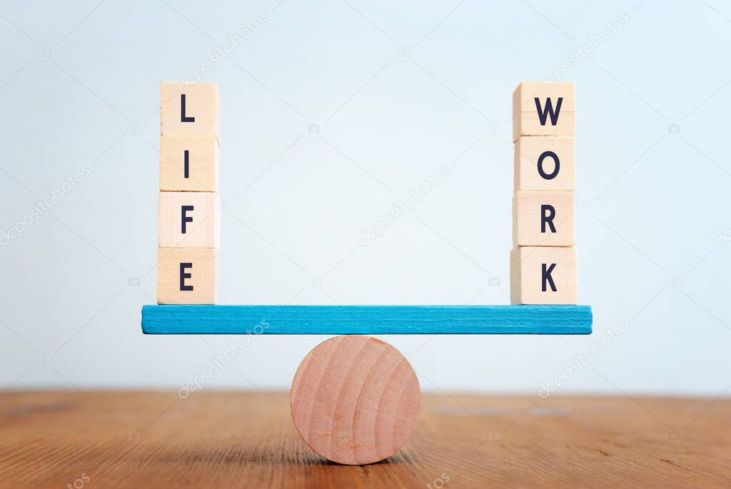 Concept of finding the right balance. Wooden cubes on seesaw