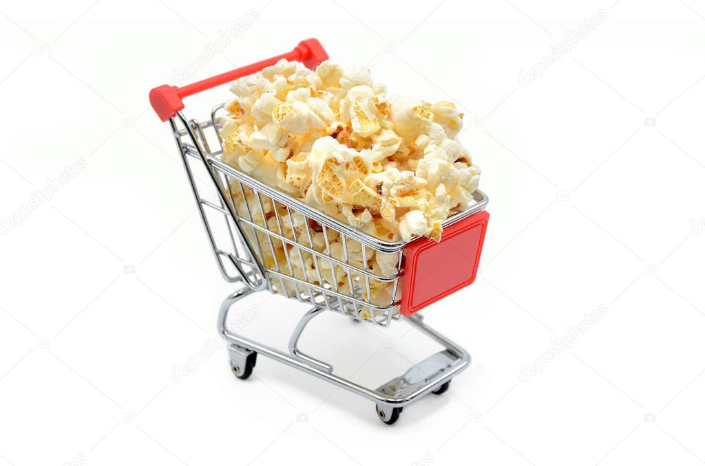 shopping cart filled with popcorn on white background