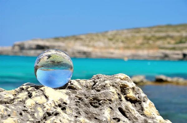 crystal sphere on the rocks with water
