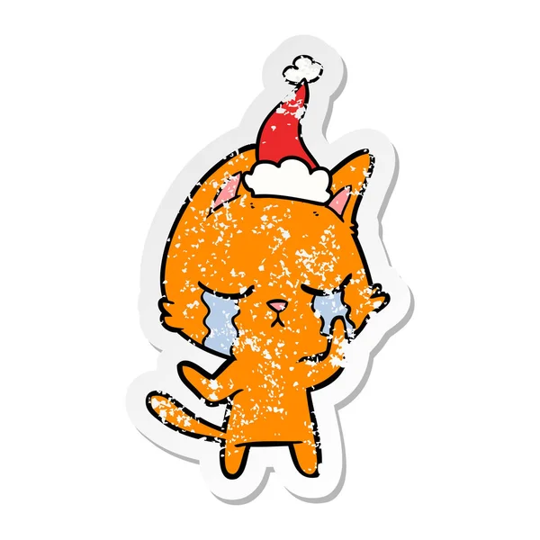 Autocollant en pleurs affligé dessin animé d'un chat portant un chapeau de Père Noël — Image vectorielle