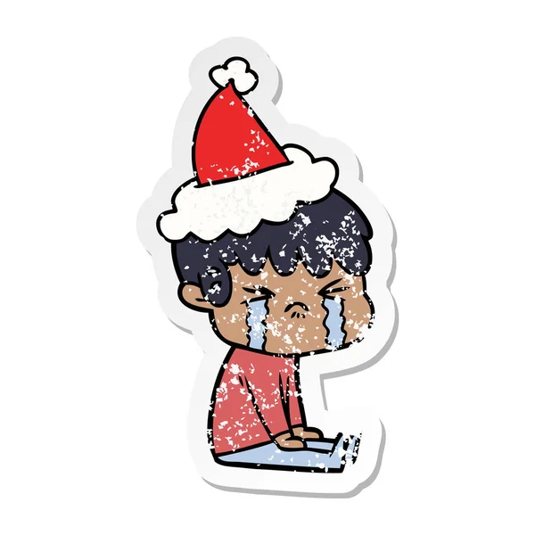 Distressed sticker cartoon of a boy crying wearing santa hat — Stock Vector