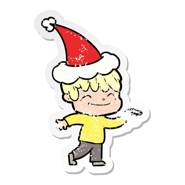Nödställda klistermärke cartoon av en glad pojke som santa hatt — Stock vektor