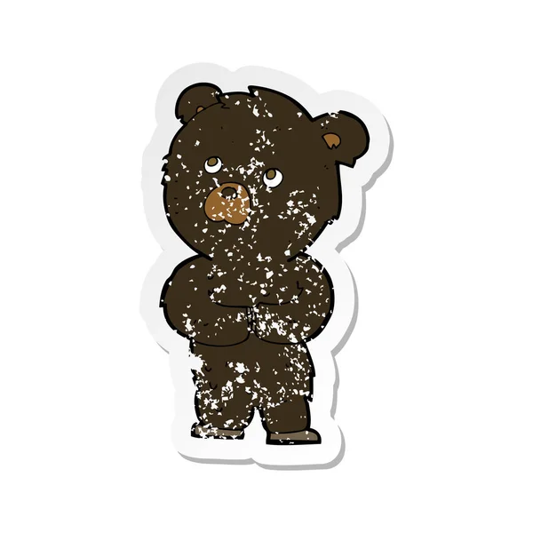 Retro adesivo angosciato di un fumetto cucciolo di orso nero — Vettoriale Stock