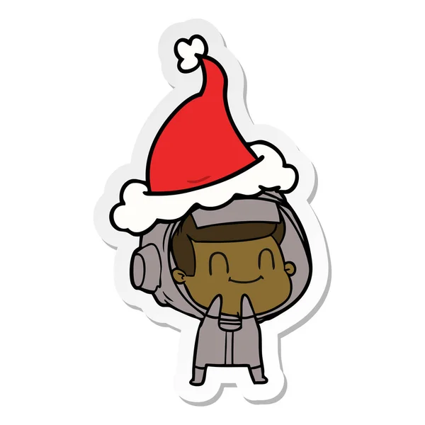 Fröhliche Sticker-Karikatur eines Astronauten mit Weihnachtsmütze — Stockvektor