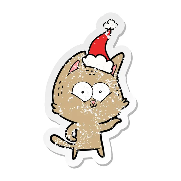 Autocollant affligé dessin animé d'un chat portant un chapeau de Père Noël — Image vectorielle