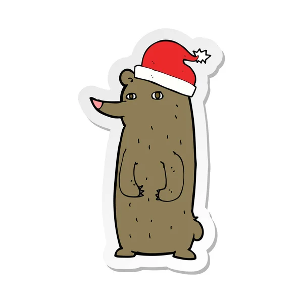 Aufkleber eines Cartoon-Bären mit Weihnachtsmütze — Stockvektor