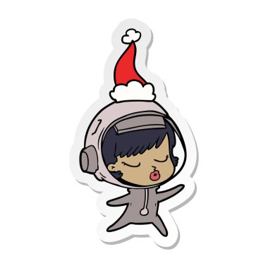 çizilmiş etiket karikatür Noel Baba şapkası giyen bir güzel astronot kızın el