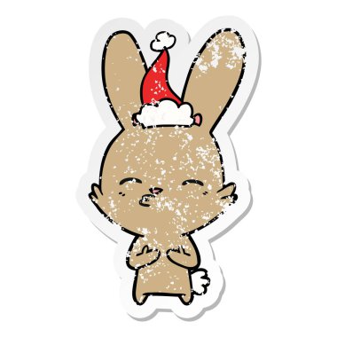 meraklı bunny el sıkıntılı etiket karikatür giyen Noel Baba şapkası, çekilmiş
