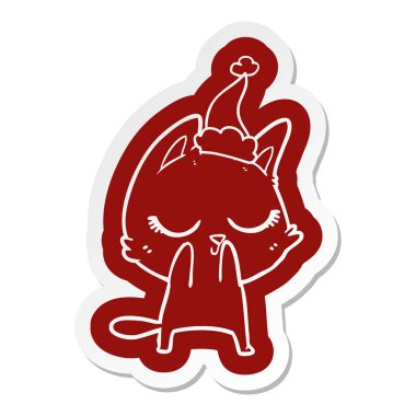 Noel Baba şapkası giyen bir kedinin ilginç çizgi film etiketi sakin