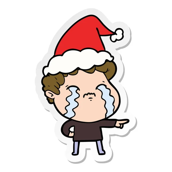 Autocollant dessin animé d'un homme pleurant portant le chapeau de Père Noël — Image vectorielle