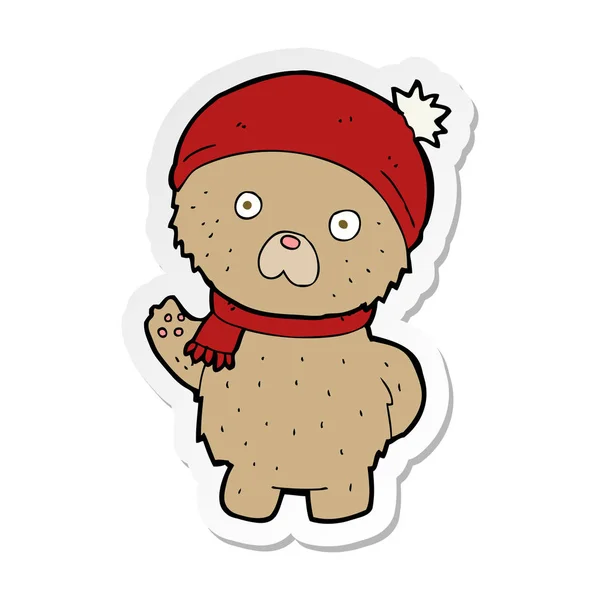 Autocollant d'un ours en peluche dessin animé en chapeau et écharpe d'hiver — Image vectorielle