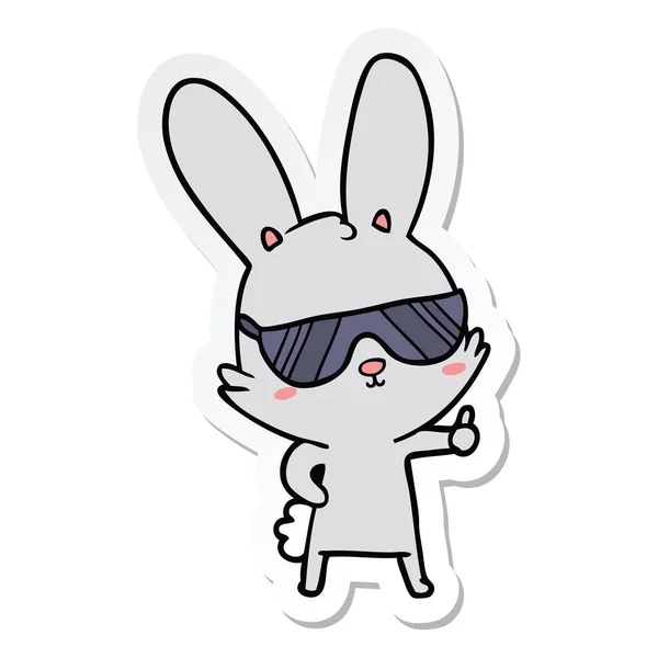 Klistermärke av en gullig tecknad kanin bär solglasögon — Stock vektor