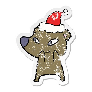 sıkıntılı etiket karikatür Noel Baba şapkası giyen bir ayının şirin el çekilmiş