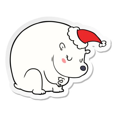 Noel Baba şapkası giyen bir kutup ayısı şirin etiket karikatür