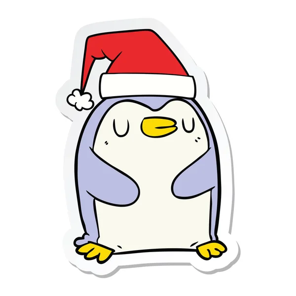 Sticker of a cartoon penguin wearing christmas hat — Stock Vector