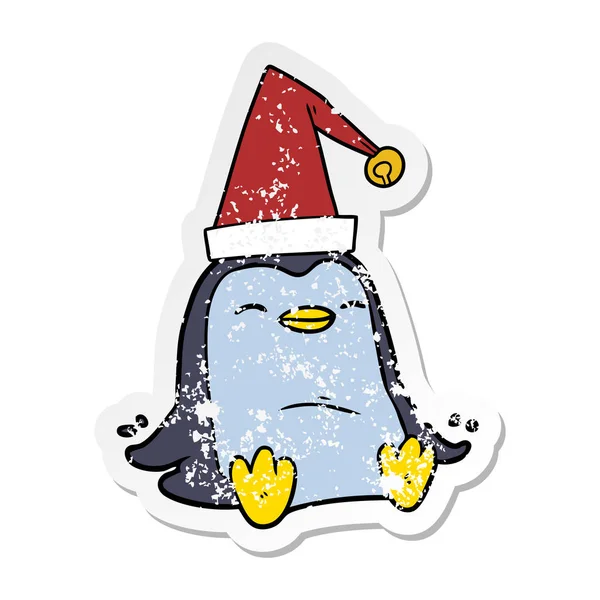 Etiqueta angustiada de um pinguim de desenho animado usando chapéu de Natal — Vetor de Stock