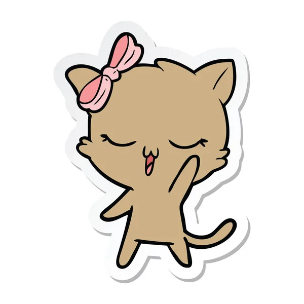 Stiker dari kartun kucing dengan busur di kepala melambai - Stok Vektor