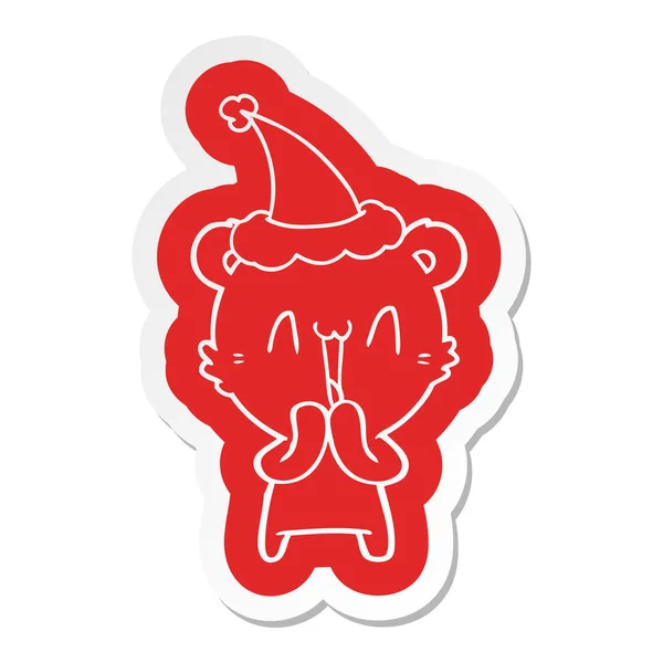 Heureux ours dessin animé autocollant d'un chapeau santa porter — Image vectorielle