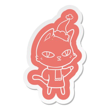 çizgi film etiketi kedi bakan giyen Noel Baba şapkası