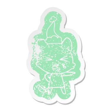 Noel Baba şapkası giyen tıslayan bir kedi çizgi film sıkıntılı etiket