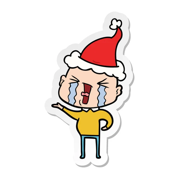 Adesivo cartone animato di un uomo calvo piangendo indossando cappello di Babbo Natale — Vettoriale Stock
