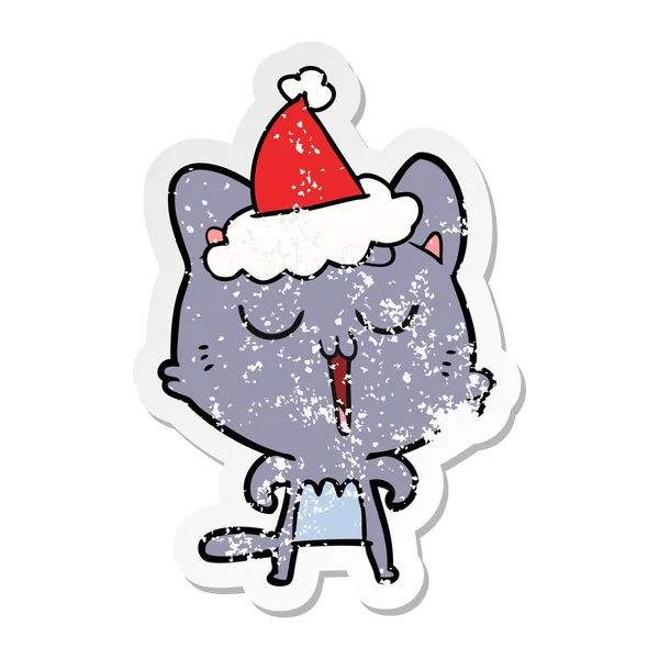 Aufkleber Karikatur einer singenden Katze mit Weihnachtsmütze — Stockvektor