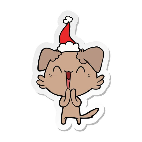 Směje se malý kreslený nálepka pes nosí čepice santa — Stockový vektor
