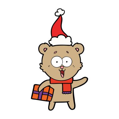 oyuncak ayı Noel Noel Baba şapkası giyen hediyesi ile gülüyor