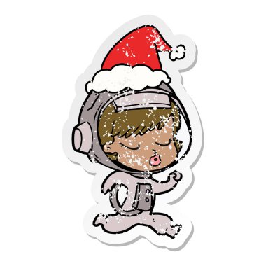 elle çizilmiş etiket karikatür giyen Noel Baba şapkası çalıştıran bir güzel astronot kızın sıkıntılı