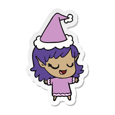 etiket karikatür Noel Baba şapkası giyen bir elf kızın mutlu el çekilmiş