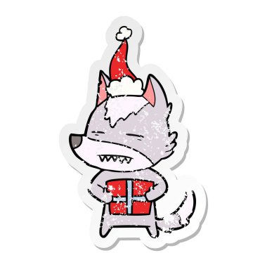 sıkıntılı etiket karikatür santa s giyen bir hediye ile bir kurt