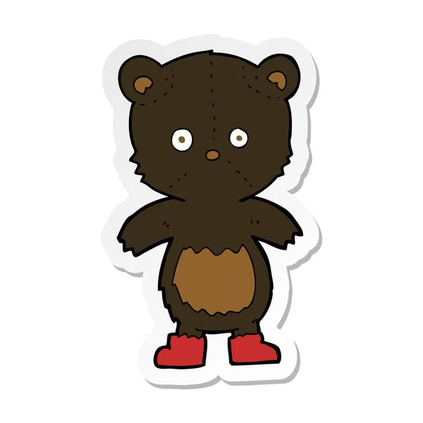 Sticker of a cartoon black bear cub — Stock Vector