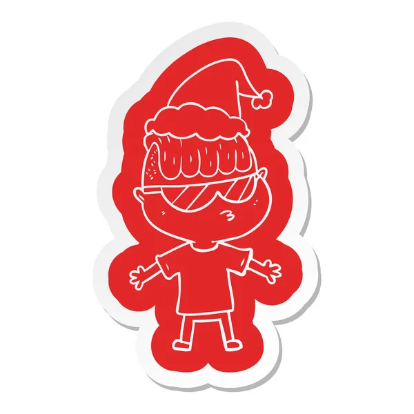 Cartoon-Sticker eines Jungen mit Sonnenbrille und Weihnachtsmütze — Stockvektor
