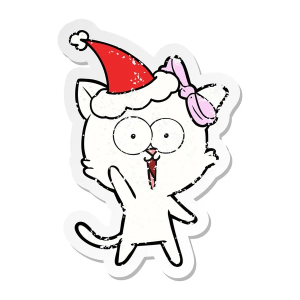 Sıkıntılı etiket karikatür Noel Baba şapkası giyen bir kedi — Stok Vektör