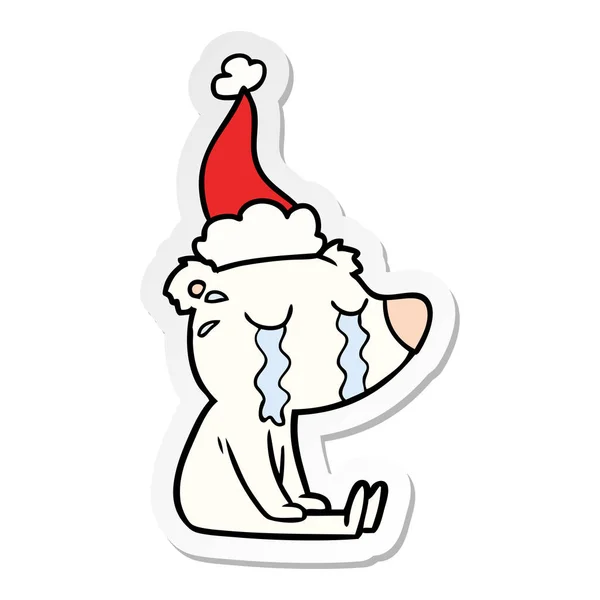 Klistermärke cartoon av en gråtande sittande isbjörn santa hatt — Stock vektor