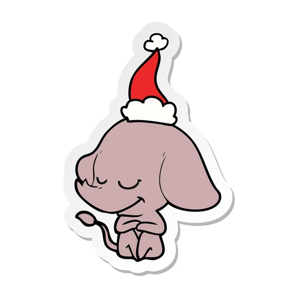 Pegatina de dibujos animados de un elefante sonriente con sombrero de santa — Vector de stock