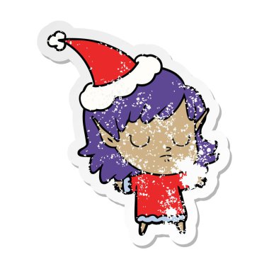 Noel Baba şapkası giyen bir elf kızın sıkıntılı etiket karikatür el çekilmiş
