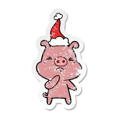 sıkıntılı etiket karikatür kızgın domuz Noel Baba şapkası giyen bir el çekilmiş