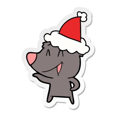 ayı gülerek el etiket karikatür giyen Noel Baba şapkası, çekilmiş