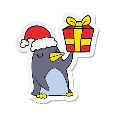 Noel hediyesi olan bir karikatür penguen etiket