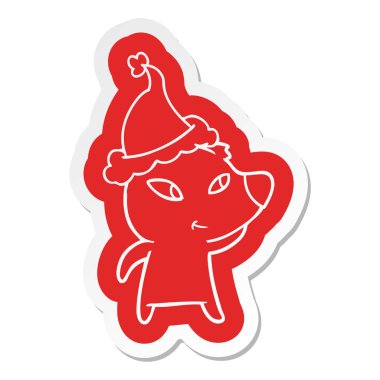 Noel Baba şapkası giyen bir ayının sevimli ilginç çizgi etiket