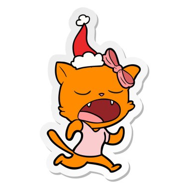 etiket karikatür Noel Baba şapkası giyen bir esneme kedi el çekilmiş