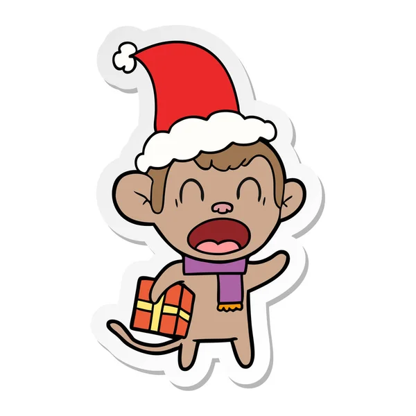 Shouting sticker cartoon of a monkey carrying christmas gift wea — Stock Vector