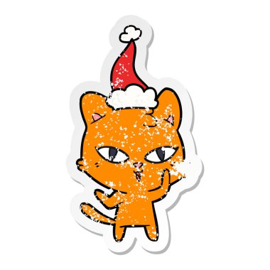 sıkıntılı etiket karikatür Noel Baba şapkası giyen bir kedi el çekilmiş
